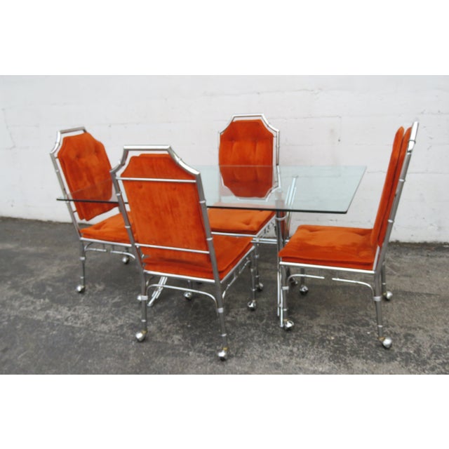This Set of Dining Dinette Table and Chairs is made out of metal, chrome, glass, and upholstery. The Set has Hollywood...