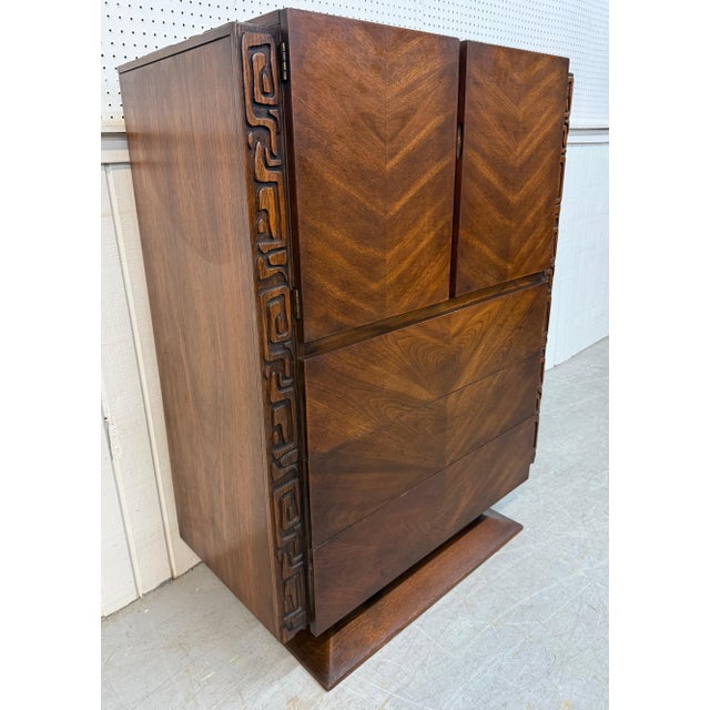 This listing is for a Mid-Century Modern United Tiki Walnut High Chest. Featuring a straight line brutalist design, two...