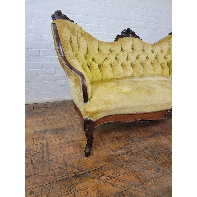 Antique Yellow Loveseat With Carved Wood and Tufted Yellow Velvet