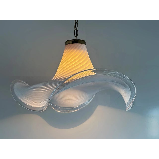 Mid-century Hand Blown Swirled Murano Glass Pendant Chandelier Offered for sale is a sinuously curved Mid-century hand-...