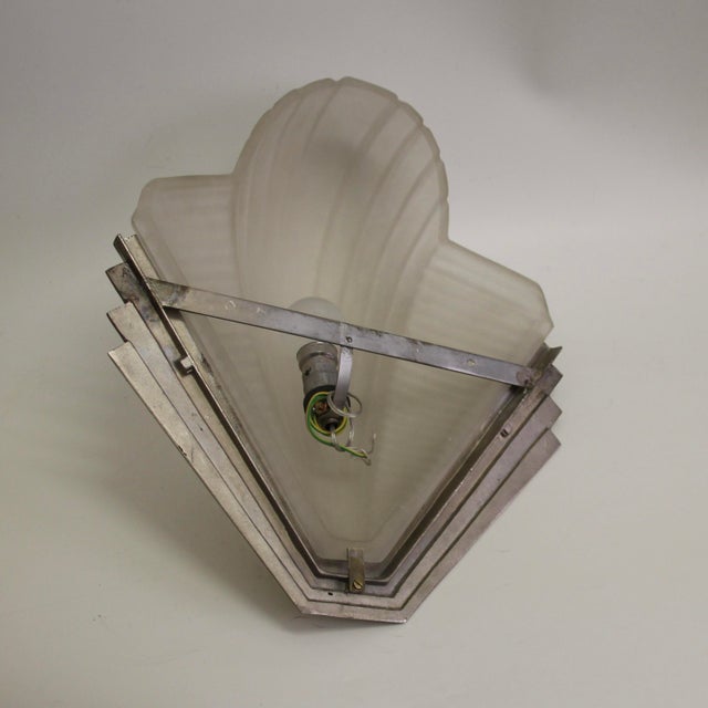 Large Petitot wall lights with a distinctive Art Deco motif in the streamlined glass shades. The solid brass brackets are...