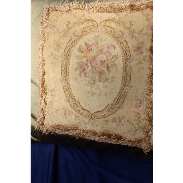 This is an antique French Aubusson pillow. The piece dates back to the late 19th century.