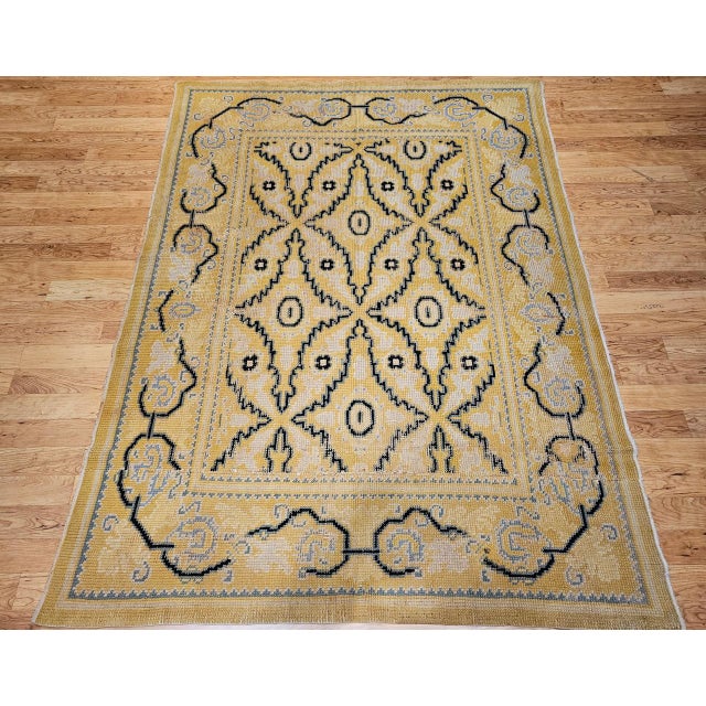This exquisite vintage French area rug from the first quarter of the 20th century is a rare and remarkable piece — a room-...