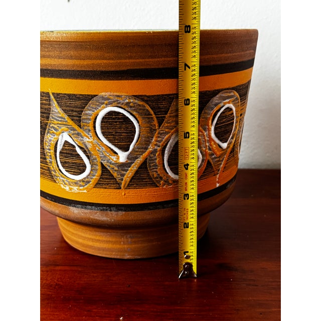 Vintage mid-century modern ceramic planter featuring a bold dimensional glossy glaze design over a mostly matte brown and...