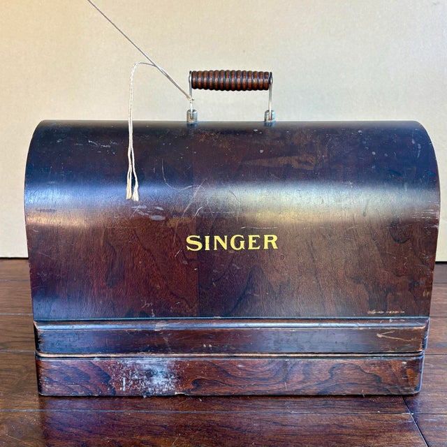 Vintage Singer 128, 1923 sewing machine. Beautifully preserved and electric-powered with original case and key. These...