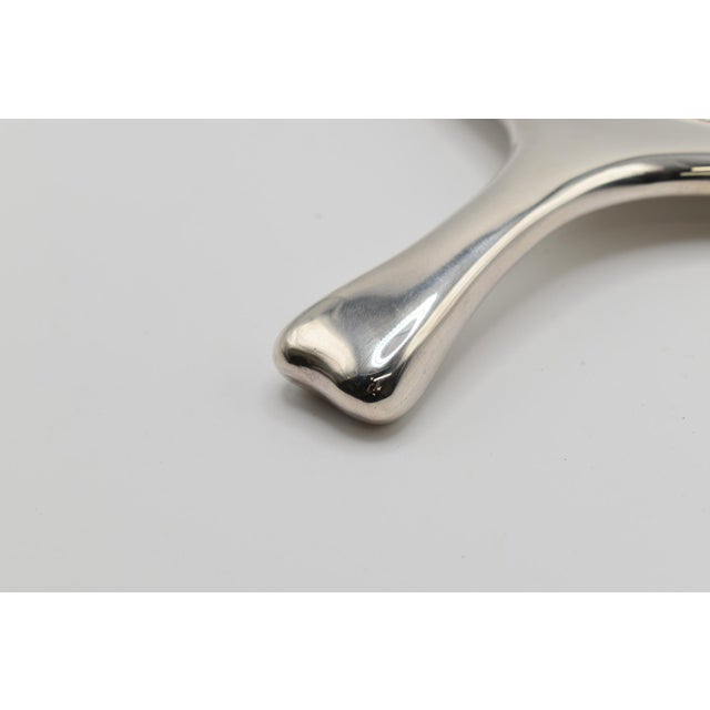 This is a stunning Tiffany & Co. hand mirror. It is made of Sterling Silver with markings. It is stamped "Tiffany & Co....