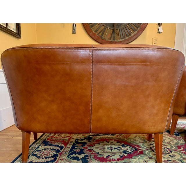 Rescued from a Parisian houseboat on the Siene, cognac/tan leather loveseat and a matching pair of club chairs with...