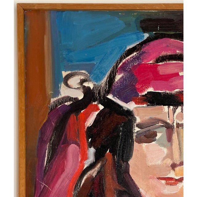 Framed in natural wood, this painting features energetic strokes of teal, brown, rose, red, lavender, orange, and...