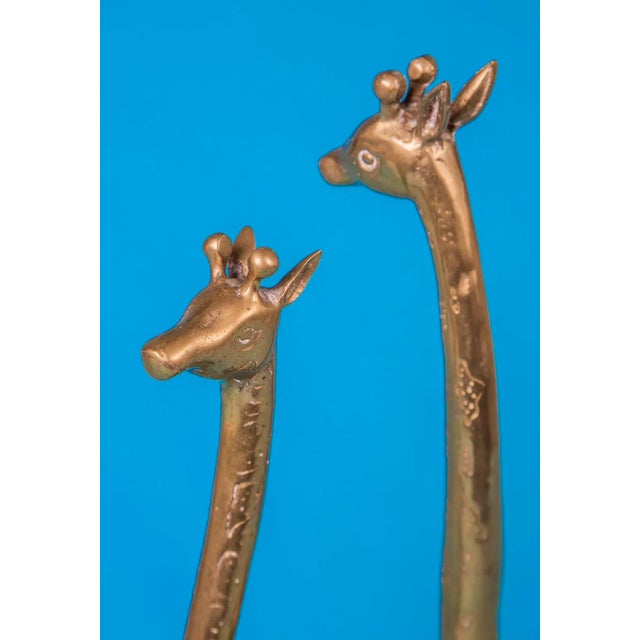 Beautiful pair of 1970's vintage solid brass giraffes. Smaller:15.75"T x 5.5"D x 1.5"W Larger: 17.5T x 8.5"D x 2"W