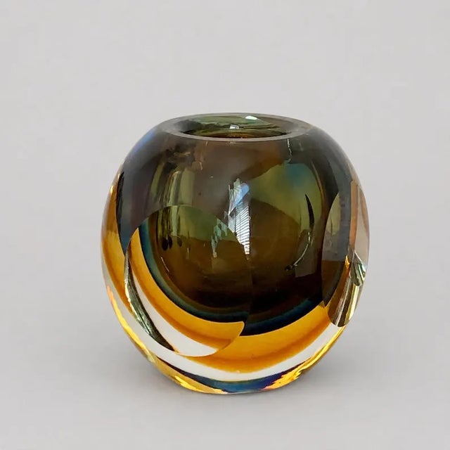 A striking vintage Italian sommerso art glass vase distinguished by dramatic layers of amber, cobalt blue, smoky olive,...