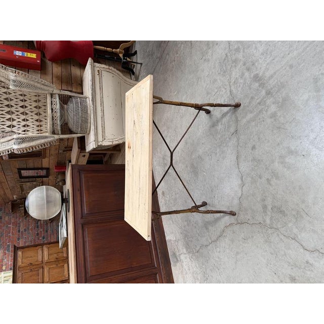This antique bistro table has been fully restored. It features a raw wood (poplar) top and a cast iron base that retains...