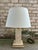 Vintage travertine table lamp with brass detail from France. The travertine that makes up the lamp is honed / matte and...