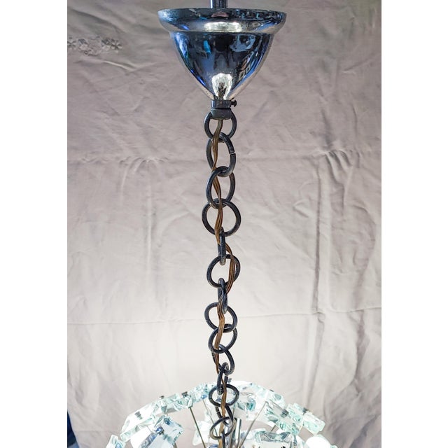 Spherical chandelier by the Italian company Fontana Arte, Sputnik model. Chromed structure with 13 lights and hand-cut and...