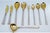 Reed Style Gold Cutlery with Raised Handles, Set of 9, in Very Good conditions. Designed 1920 to 1949 This piece has an...
