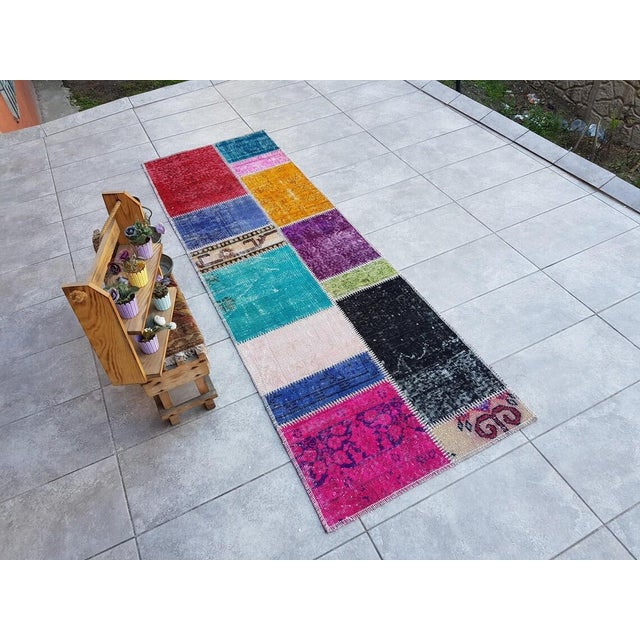 This is a vintage Turkish Oushak rug from the Mid 20th Century. The piece was hand-knotted.