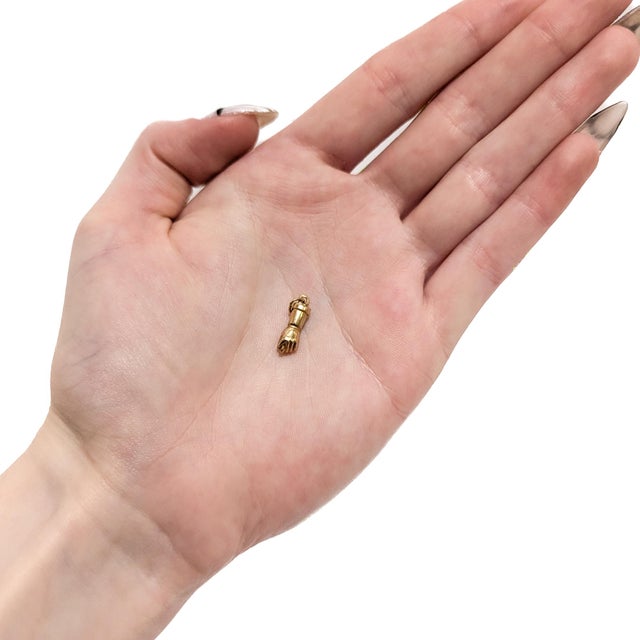 A fine vintage gold fig sign pendant or charm for a charm bracelet. In 14 karat yellow gold. In the form of the fig sign...