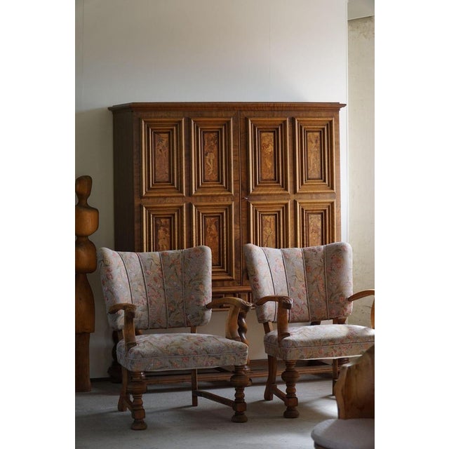 A pair of exquisite armchairs from the early 20th century, crafted by a skilled Danish cabinetmaker. Embracing the...