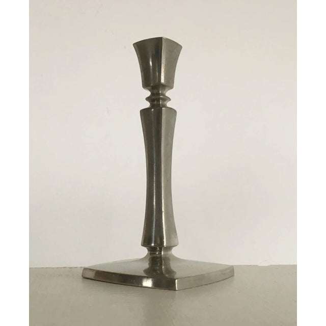 Set of two Danish Just Andersen pewter candle holders produced by Just Andersen A/S in the 1940's. The well designed...