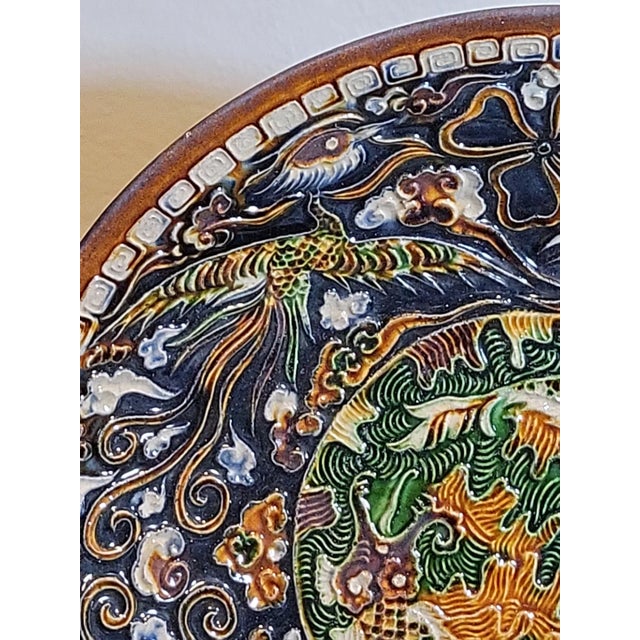 Gorgeous 18th century plate with intricate handpainted enamel of fish in the center and phoenix throughout. Stunning!