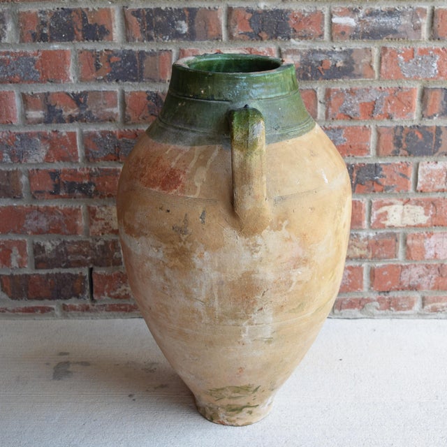 This antique Turkish olive jar is a stunning piece of Mediterranean pottery that will add a touch of rustic European charm...