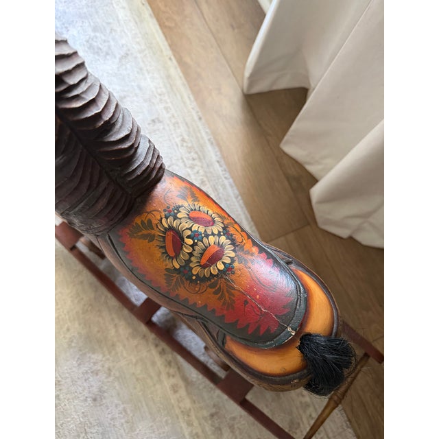 Beautiful antique hand-painted and carved wooden rocking horse with an unusual wheeled platform and separate bow-rocker...