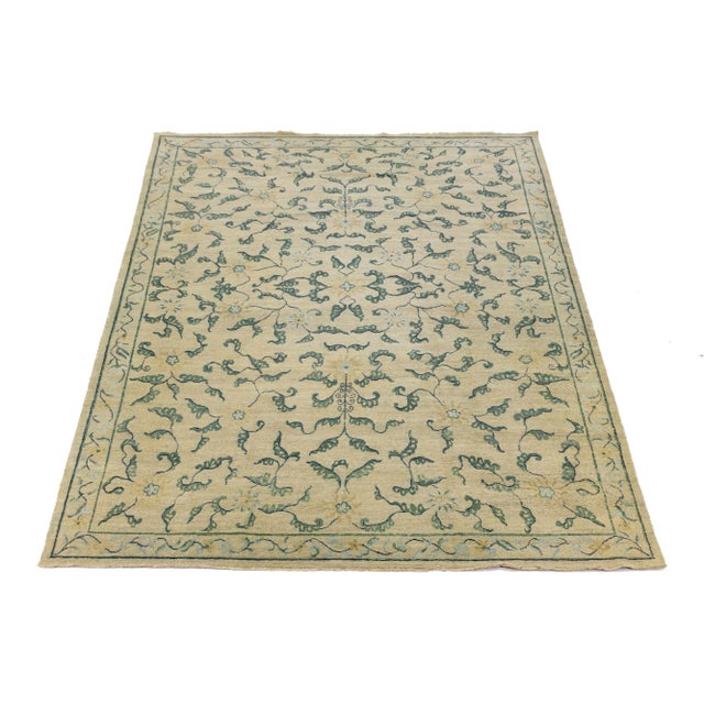 This contemporary hand-knotted rug showcases a stunning floral design with a green color scheme. Crafted from high-quality...