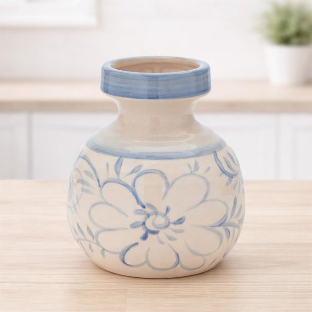 Add a touch of timeless charm to your space with this Blue Floral Stoneware Decorative Container. Showcasing a floral...