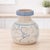 Add a touch of timeless charm to your space with this Blue Floral Stoneware Decorative Container. Showcasing a floral...