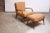1950s Italian walnut lounge chair and ottoman designed by Carlo de Carli for M. Singer & Sons. Features a highly sculpted,...