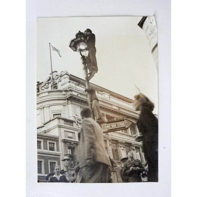 Vintage circa 1940's photograph of men climbing street light. Likely english, great perspective. Unsigned. Unframed, age...