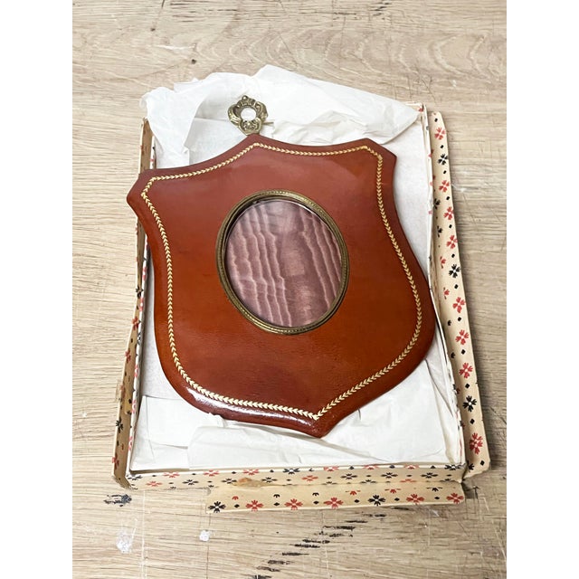 Vintage Italian Leather Shield Picture Frame with gilt edging and an oval cut glass opening for a picture. Measures 6 x...