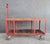 Unusual industrial rolling cart with retractable handle. Red painted steel with solid oak top surface. Wood at base...