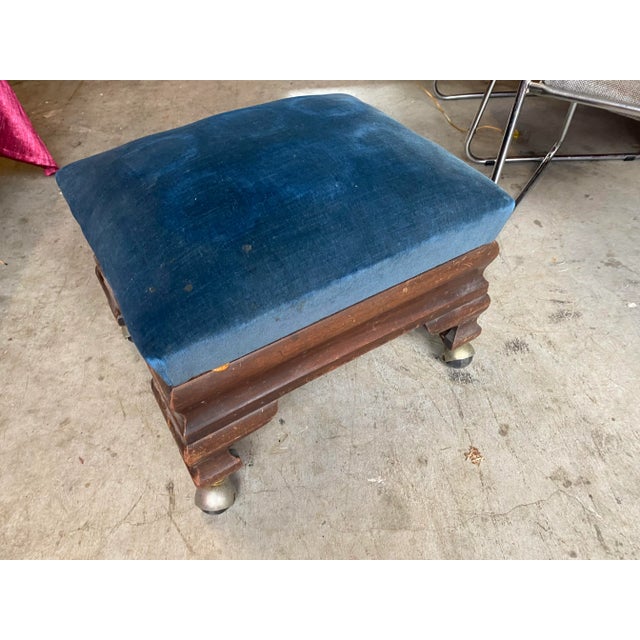 A beautiful blue velvet covered wooden ottoman/ footstool on wheels. Perfect for the interior designer or the enthusiast!