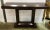 Stylish modern dark walnut wood console table, showroom floor sample