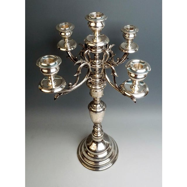 Decorative large five-light silver candelabra on a round base, with embossed and chased geometric and floral decor. Finest...