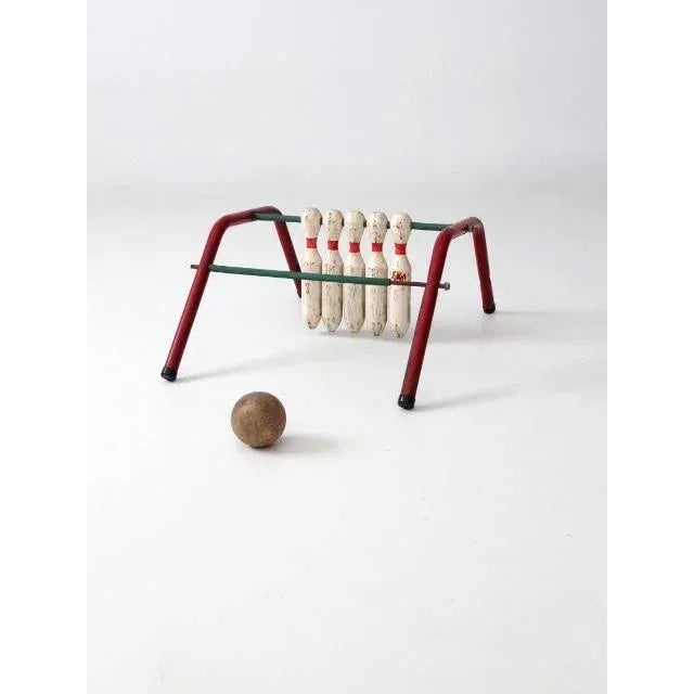 A mid-century “Five Pins” tabletop bowling game by Mansfield Zesiger Mfg. Co., Ohio, circa 1950s. The game features a red...