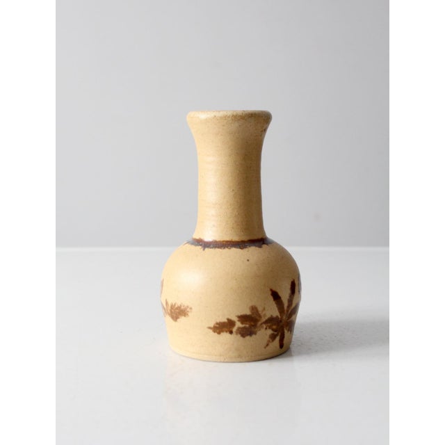 This is a vintage studio pottery vase. Reminiscent of mid-century Pottery Craft pieces, the handmade vase has a natural,...