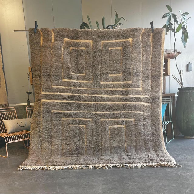 Discover the unique elegance of this handmade Moroccan Mrirt rug, designed with a minimalist grid of soft-textured . This...