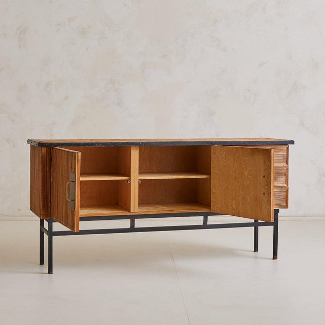 Crafted in France in the 1960s, this low sideboard is a striking study in material rhythm and sculptural restraint....