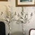 Pair of white painted metal wall sconces featuring a decorative leaf design. Great for ambient lighting with candle-style...