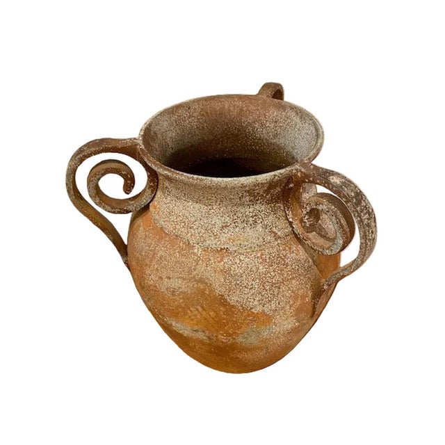 Handcrafted metal urn with authentic primitive charm, featuring three coiled handles for distinctive visual appeal and...