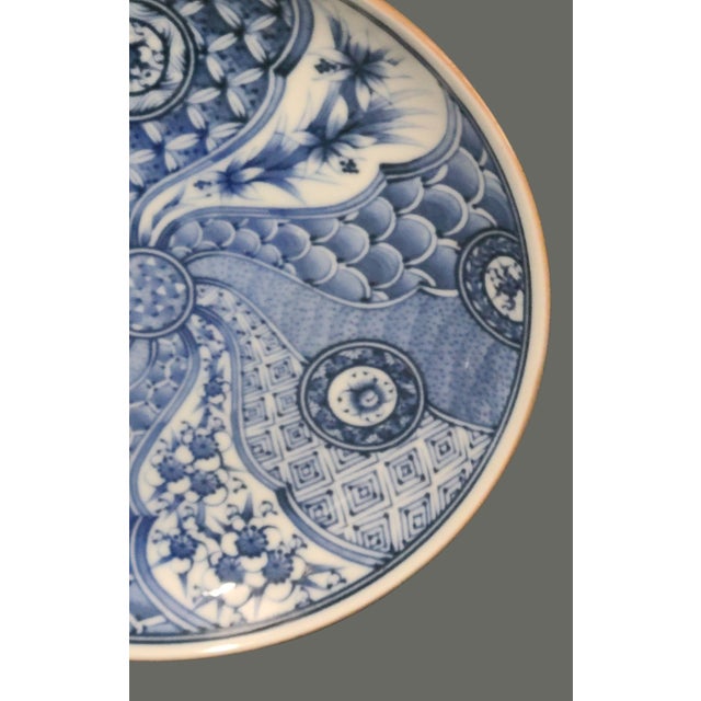 Immerse yourself in the timeless elegance of this Vintage Japanese Porcelain Plate, a stunning piece that radiates the...