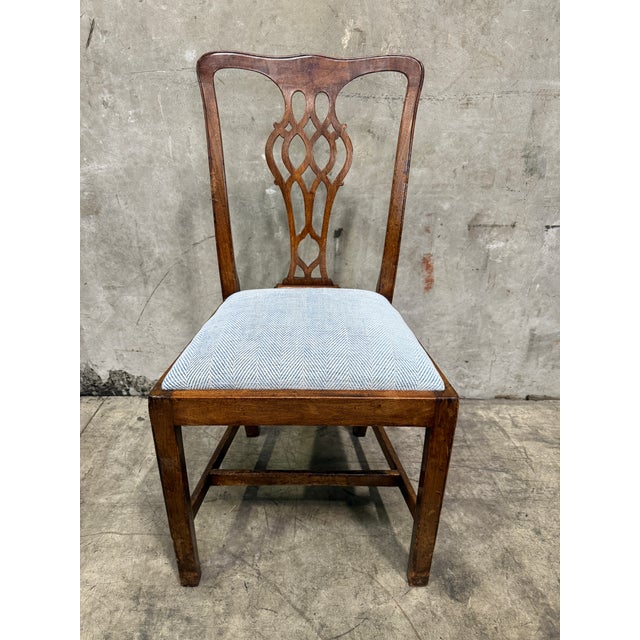 A handsome set of eight antique solid mahogany dining chairs in the classic Chippendale style, dating to circa 1830. This...