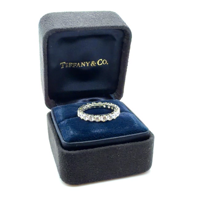 This beautifully classic ring by Tiffany & Co. contains 20 round brilliant cut diamonds weighing approximately 1.80 carats...