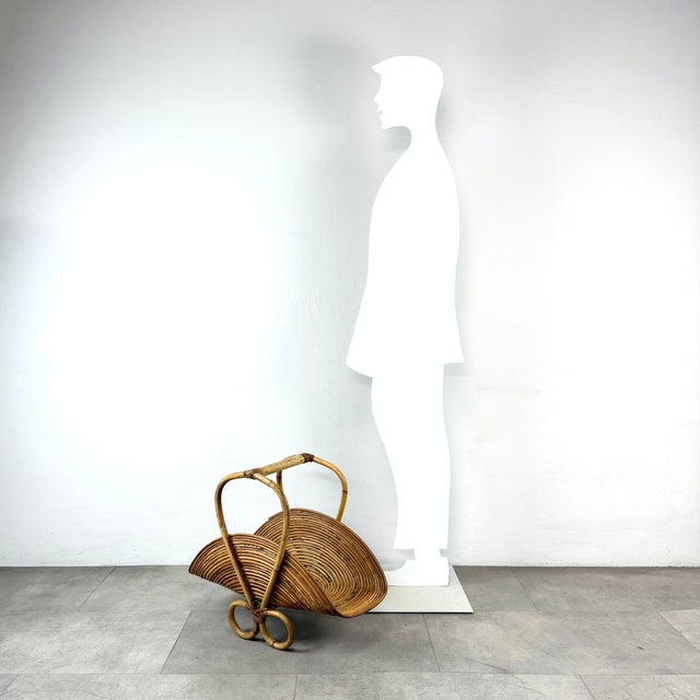 Magazine rack made of rattan wicker, Italian-made, from the 1970s. This piece is designed in the style of the selected...