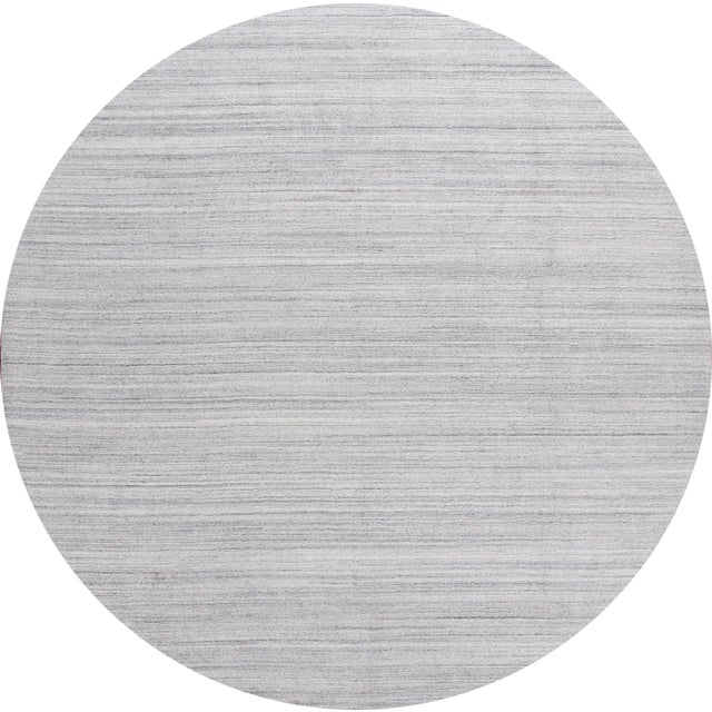 Beautiful modern solid rug; this rug is hand-knotted wool with a gray field, subtle stripe accents in a solid design. This...