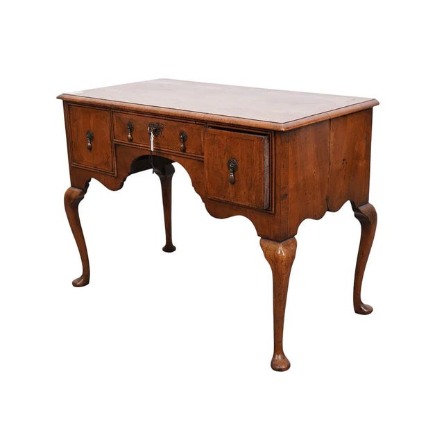 This Antique Burr Walnut Queen Anne Style Ladies Writing Desk is a stunning piece of furniture from the early 1900s,...