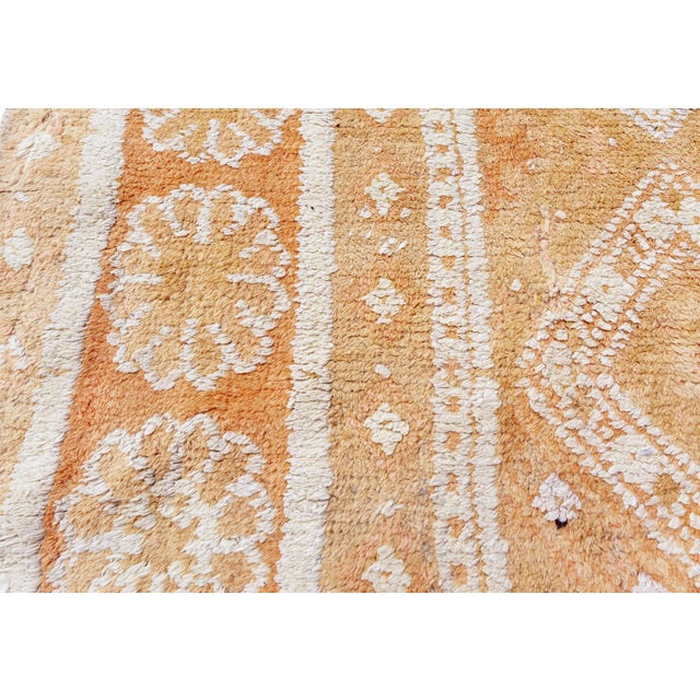 An early 20th century Indian Agra antique rug, the ochre field with an overall panel design of stepped diamond lozenges...