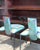 A striking pair of vintage postmodern chairs featuring sculptural black metal frames with dramatic sweeping arms and...