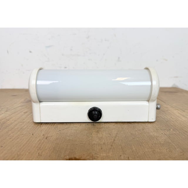 Vintage industrial white bakelite wall lamp made by Elektrosvit in former Czechoslovakia during the 1950s. It features a...